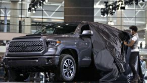 A Toyota Tundra pickup truck being unveiled at an auto show.