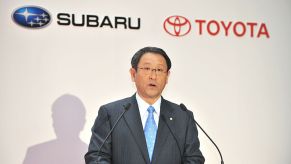 Toyota's president making an announcement about a partnership with Subaru