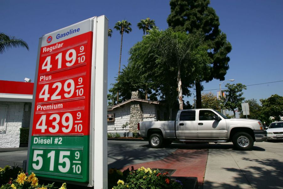 A pickup truck at a gas station about to fuel up.