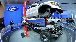 The body of a 2002 Ford F-150 Raptor truck is lifted off its chassis