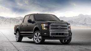 A black 2016 Ford F-150 with a dramtic grey background