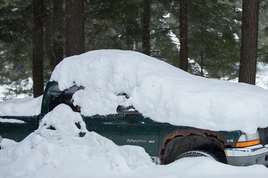 A Dodge Dakota is covered in snow