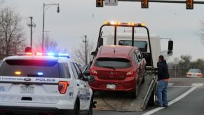 A red Mitsubishi is towed in Denve