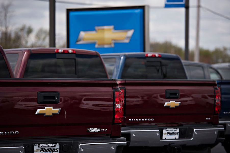 Chevy Silverado pickup trucks displayed for sale at a dealership.