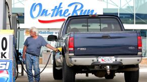 A Ford F-350 heavy-duty truck at a gas station.