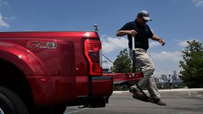 Man jumps off the tailgate of a Ford F-Series Super Duty truck