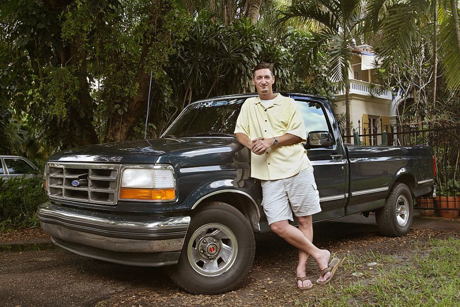 A man standing next to his Ford F-150 truck