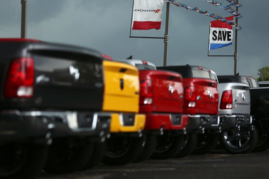 A line of trucks for sale at a car dealership.