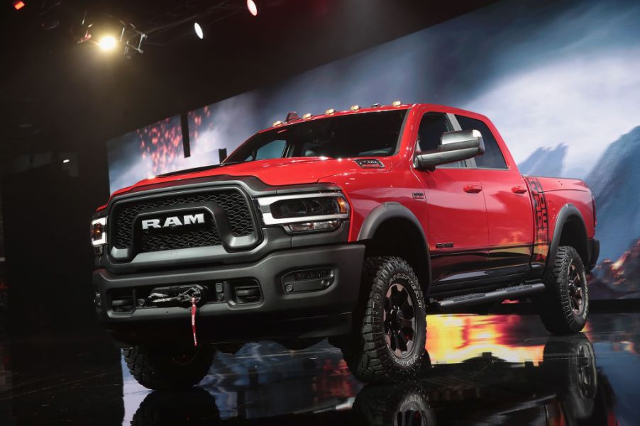 A red Ram pickup truck on display at an auto show.