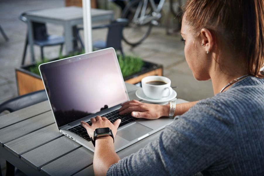 A person doing car buying research on their laptop.