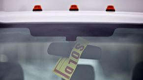 A sold sign hangs on a truck after making a sale.