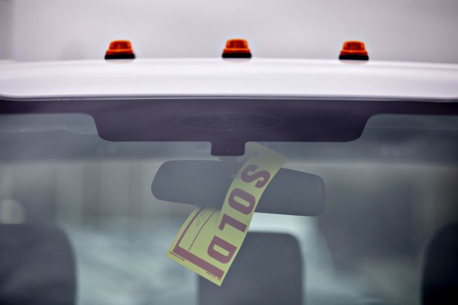 A sold sign hangs on a truck after making a sale.