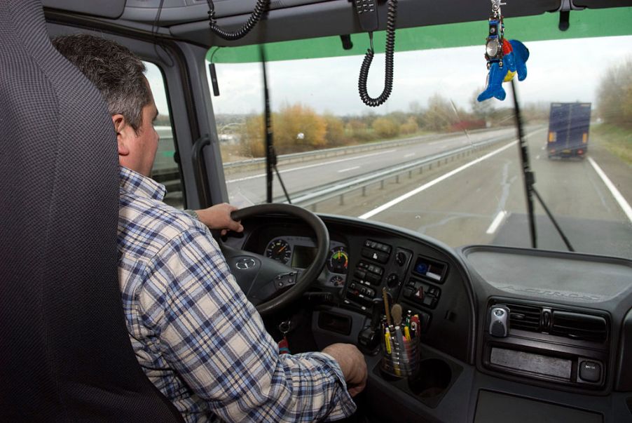 A trucker drives down the highway.