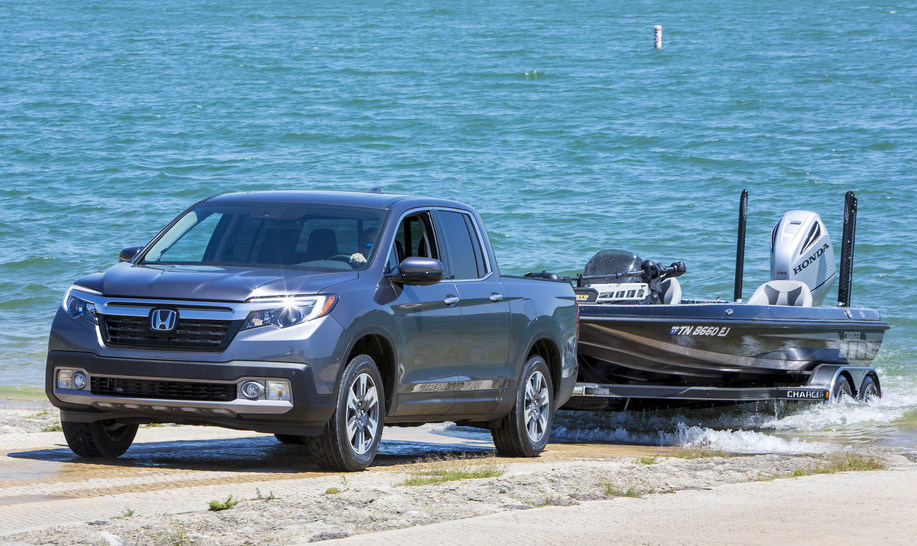 2020 Honda Ridgeline towing a boat through sand