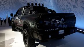 A black Nissan Titan on display at an auto show