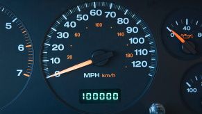 A car's odometer showing 100,000 miles.