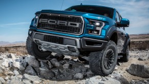 Ford F-150 Raptor climbing over rocks