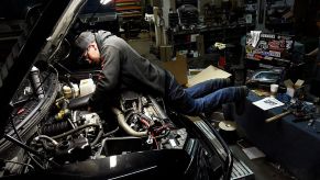 A mechanic working to fix a Ford F-150 with engine problems