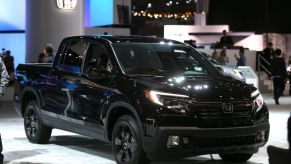 A Honda Ridgeline truck on display at an auto show.