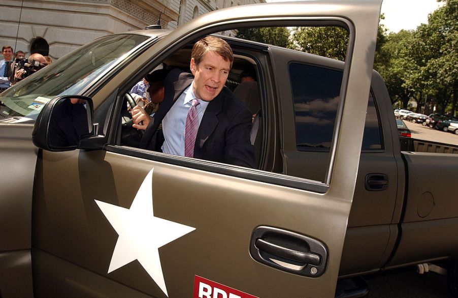 A man climbs out of a hydrogen Chevy Silverado