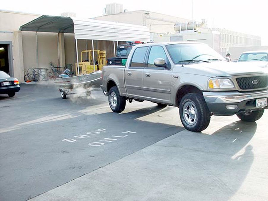 A full-size pickup truck towing a boat