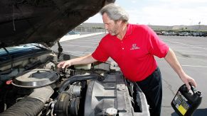 Man working on his Chevy Silverado 1500 changing the oil