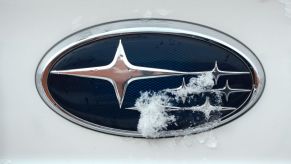 A Subaru logo on the front of a white car