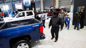 A man checks out a 2016 Chevy Silverado 1500 during an auto show