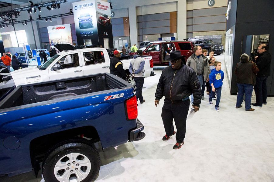 A man checks out a 2016 Chevy Silverado 1500 during an auto show