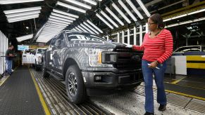 Ford F-150 trucks pass through an inspection line