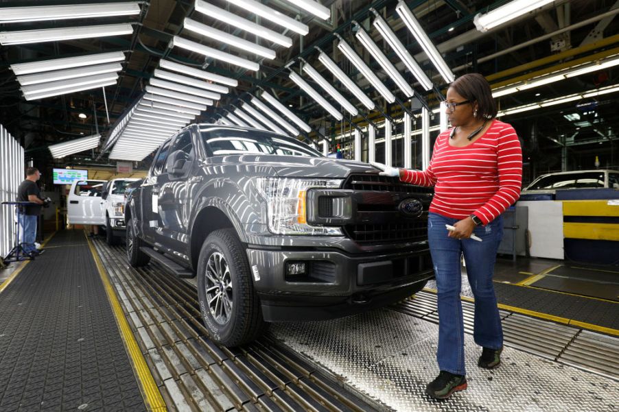 Ford F-150 trucks pass through an inspection line