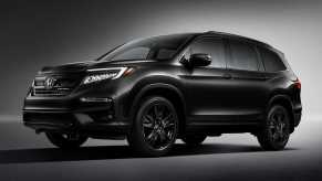 2020 honda pilot black edition press photo against a dark backdrop