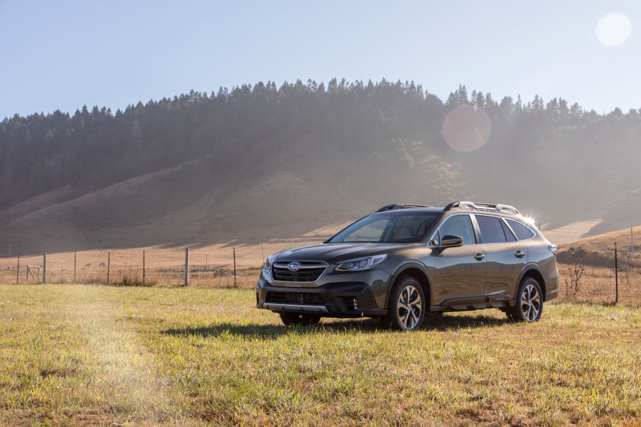 2020 Subaru Outback AWD SUV parked in a green field