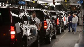 Workings in a factory assemble Chevy Suburbans