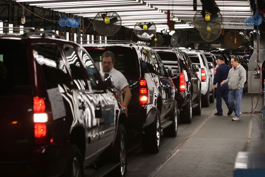 Workings in a factory assemble Chevy Suburbans