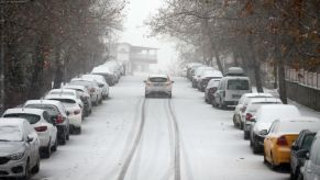 A car driving in the snow during winter season.