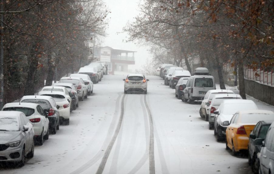 A car driving in the snow during winter season.