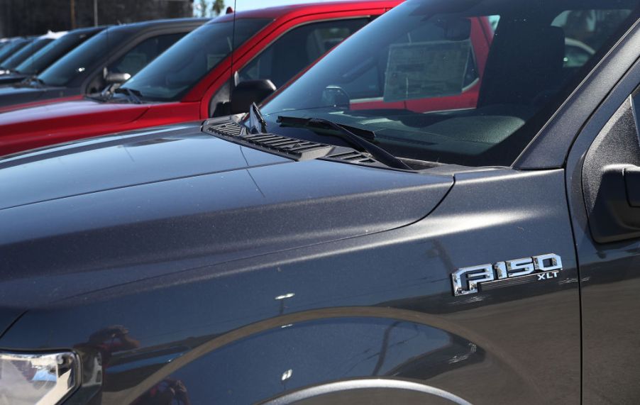 Ford F-150 models on display at a Ford dealership