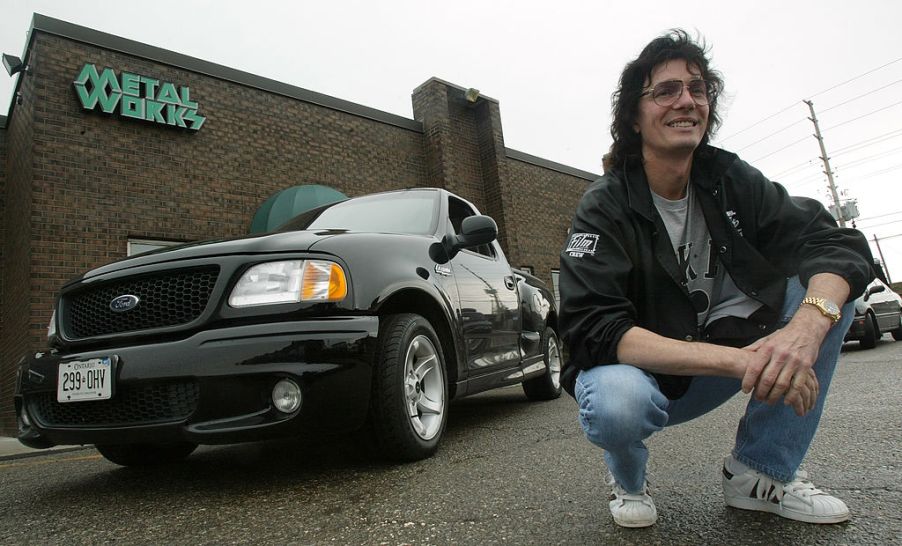 A fan poses next to a Ford SVT Lightning