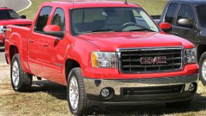 A GMC Sierra truck parked on some grass