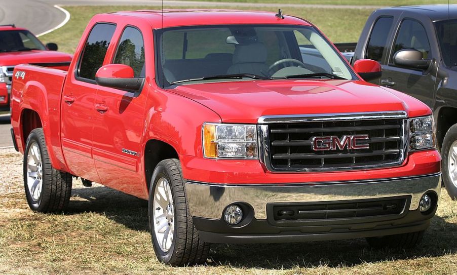 A GMC Sierra truck parked on some grass