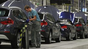 German workers assemble BMW cars at a factory