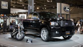 A Harley-Davidson inspired Ford truck next to a motorcycle