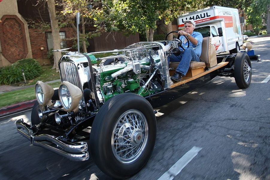 Jay Leno driving an old car