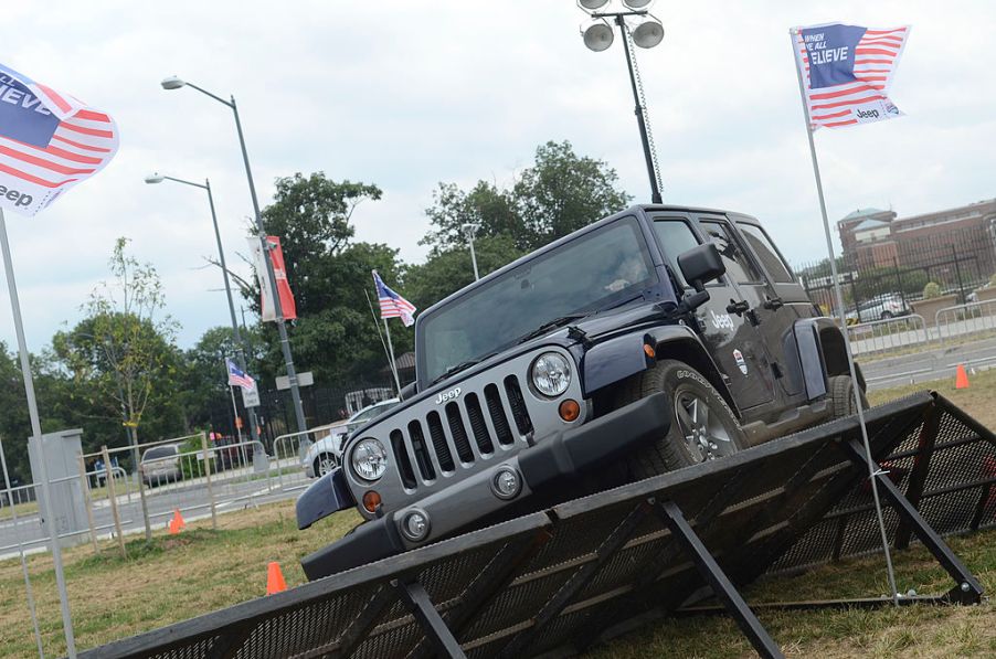 People test drive a Jeep Wrangler around a course