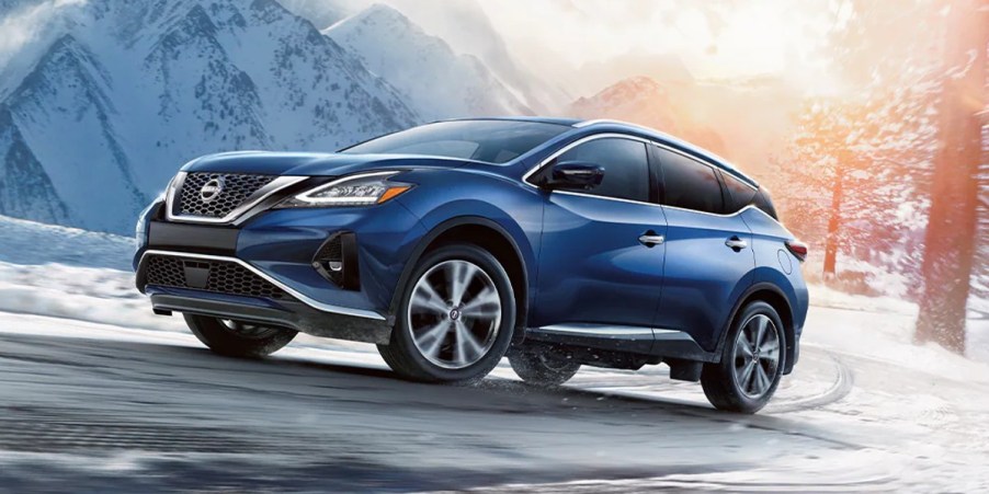 A blue Nissan Murano midsize SUV is driving.