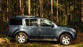 A 2005 Nissan Pathfinder parked in the woods