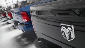 Ram pickup trucks parked in a dealership sales lot