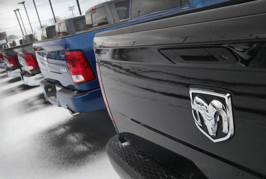 Ram pickup trucks parked in a dealership sales lot