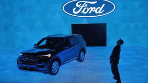 Workers prepare for a demonstration featuring the new 2020 Ford Explorer at the North American International Auto Show